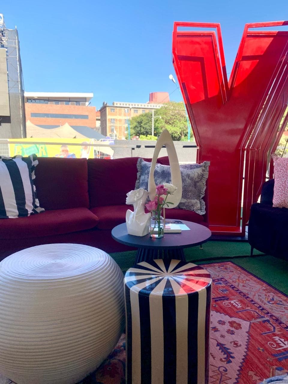 Corporate lounge activation with signature red sculpture and layered seating