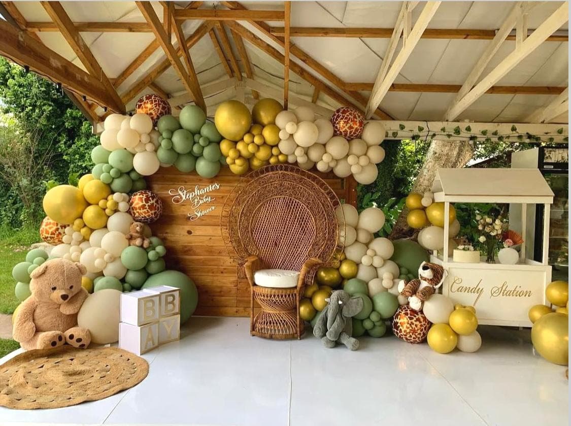 Safari-themed celebration styling under a wooden pavilion with candy station